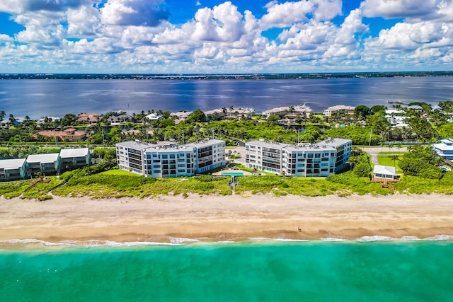 aerial view with a water view and a beach view