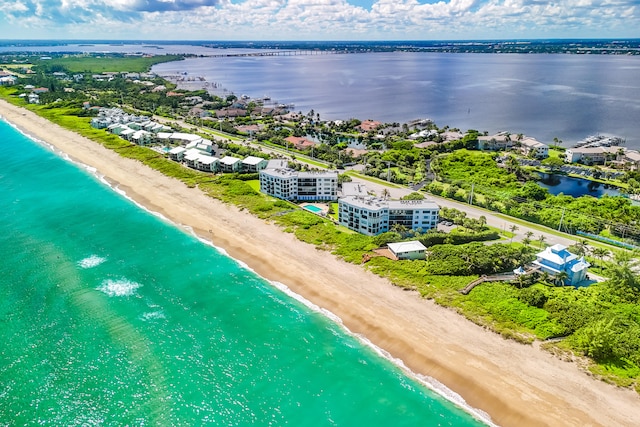 drone / aerial view featuring a beach view and a water view