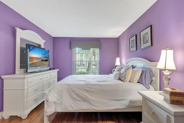 bedroom featuring a textured ceiling and hardwood / wood-style flooring