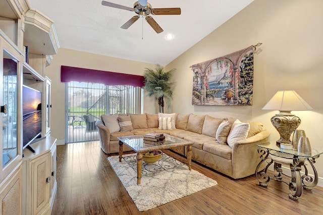 living room with ceiling fan, wood-type flooring, and vaulted ceiling