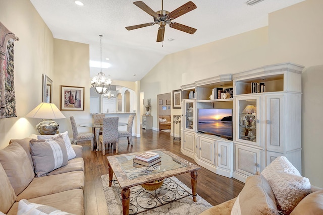 living room with high vaulted ceiling, ceiling fan with notable chandelier, dark hardwood / wood-style floors, and a textured ceiling