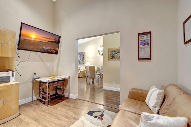 living room with lofted ceiling and light hardwood / wood-style flooring