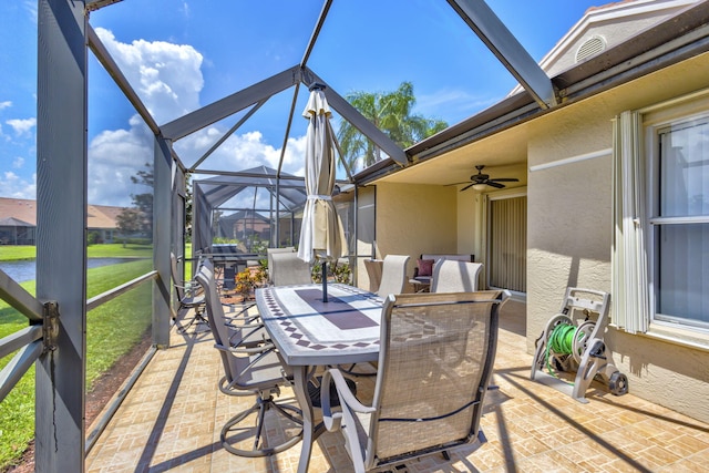 view of patio / terrace featuring ceiling fan and glass enclosure