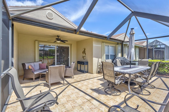 view of patio with ceiling fan, a lanai, and an outdoor living space