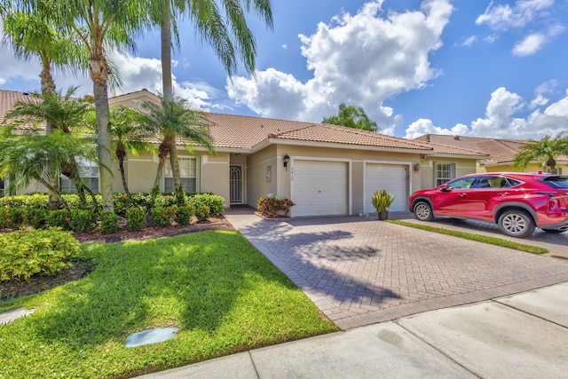 view of front of property with a garage and a front yard