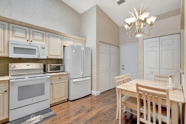 kitchen featuring cream cabinets, an inviting chandelier, white appliances, wood-type flooring, and tasteful backsplash