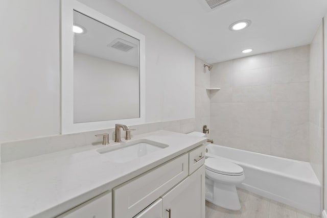 full bathroom with vanity, toilet, tiled shower / bath combo, and wood-type flooring