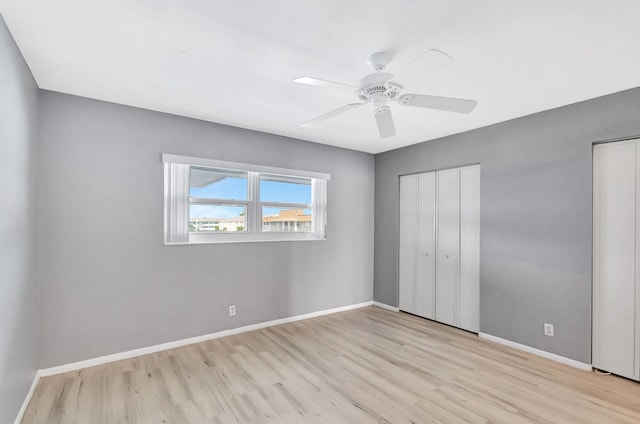 spare room featuring light wood-type flooring and ceiling fan