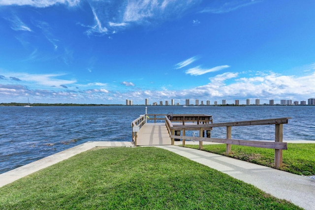 dock area featuring a water view and a yard