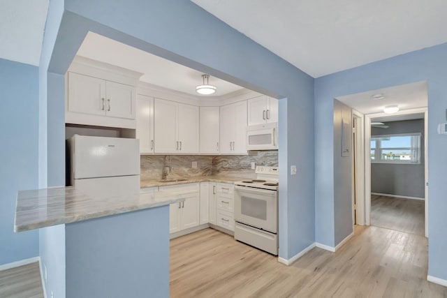 kitchen with light hardwood / wood-style flooring, sink, white appliances, and white cabinetry