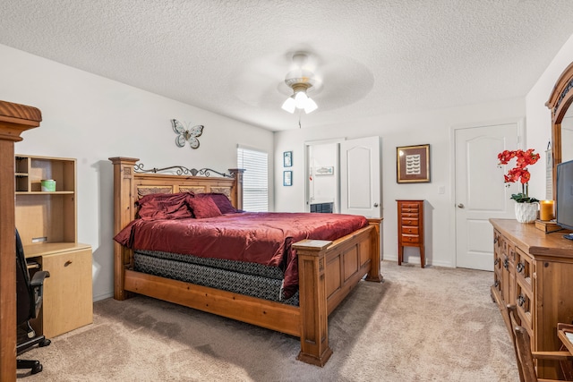 bedroom featuring ceiling fan, a textured ceiling, and carpet floors