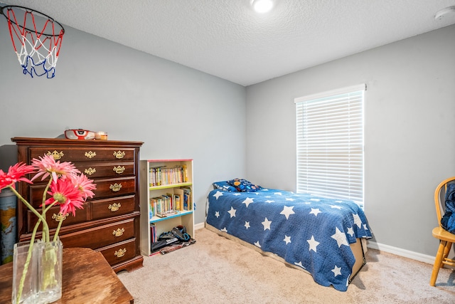 bedroom featuring a textured ceiling and carpet floors