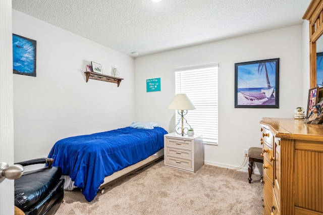 carpeted bedroom featuring a textured ceiling