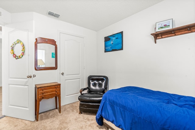 carpeted bedroom with a textured ceiling