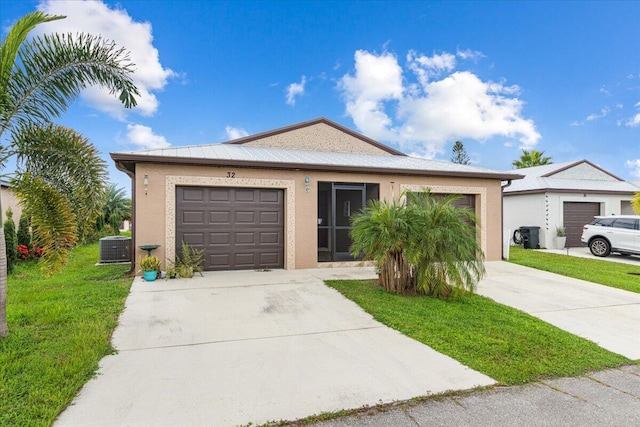 ranch-style home with a garage, central AC unit, and a front lawn