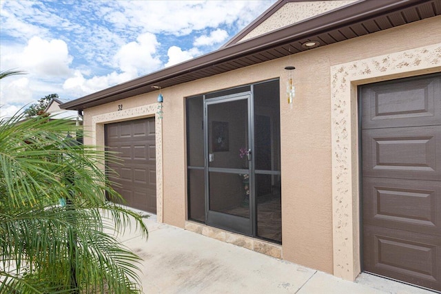 view of exterior entry featuring a garage