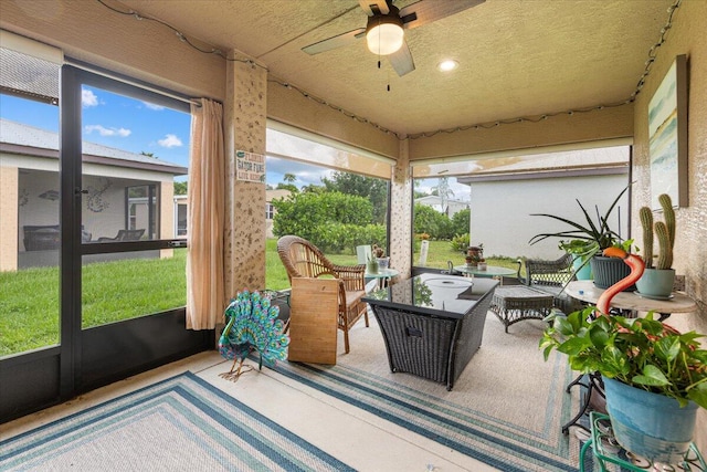 sunroom featuring ceiling fan