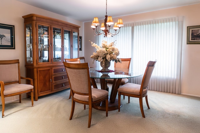 carpeted dining space with a chandelier