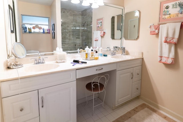 bathroom featuring tile patterned flooring, a shower with door, and vanity