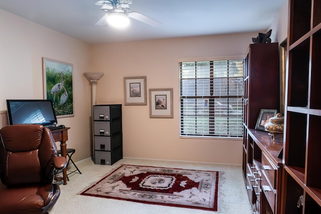 carpeted office featuring ceiling fan