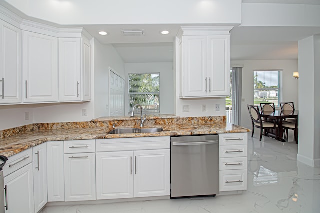 kitchen with sink, a healthy amount of sunlight, white cabinetry, and dishwasher