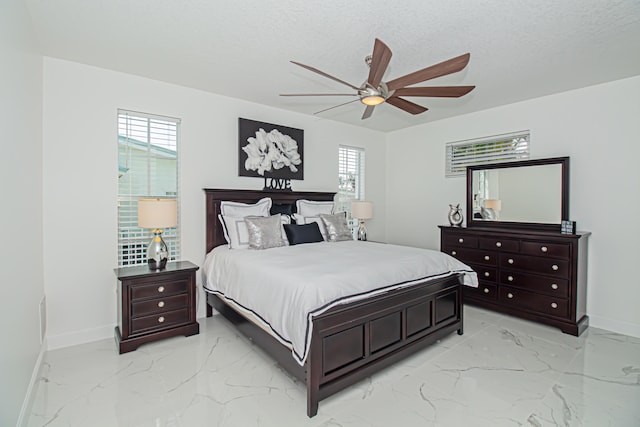 bedroom featuring a textured ceiling and ceiling fan