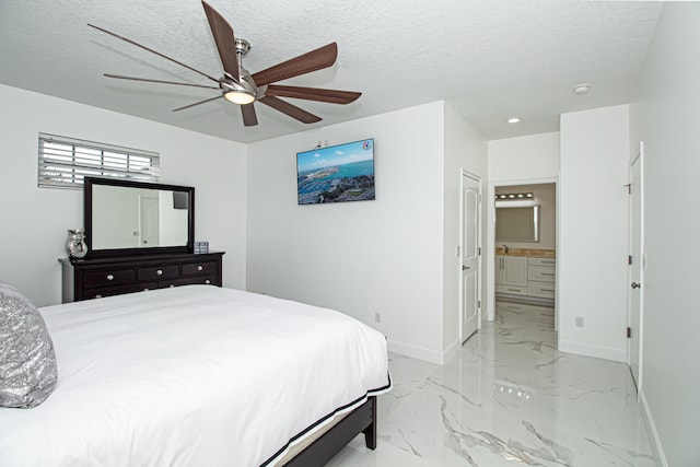 bedroom featuring ensuite bath, a textured ceiling, and ceiling fan