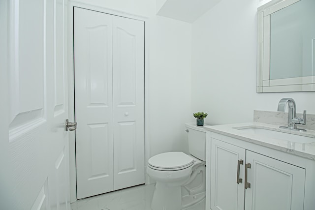 bathroom featuring toilet and vanity