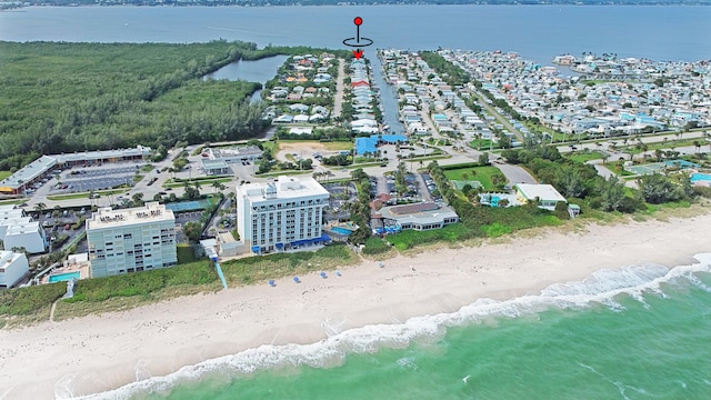 birds eye view of property featuring a water view and a view of the beach