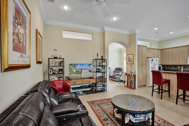 living room featuring ceiling fan, light tile patterned floors, and ornamental molding