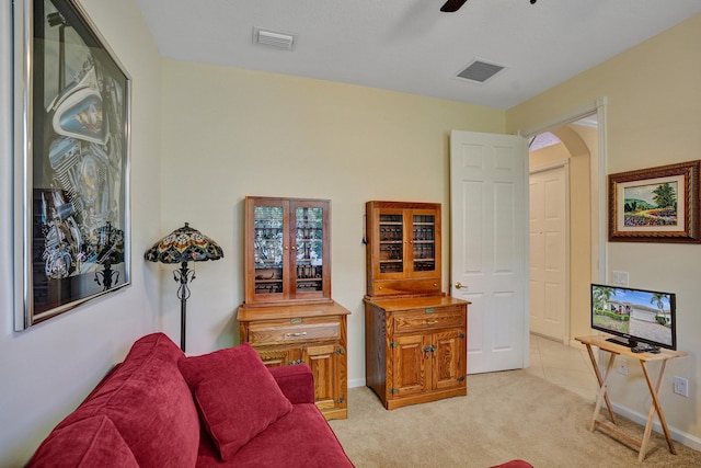 carpeted living room featuring ceiling fan