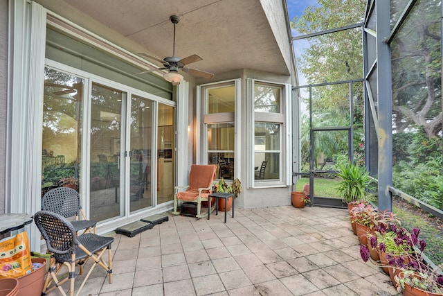 sunroom / solarium featuring ceiling fan