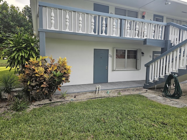 36 Islewood Unit B, Deerfield Beach, FL 33442 - view of exterior entry with a lawn