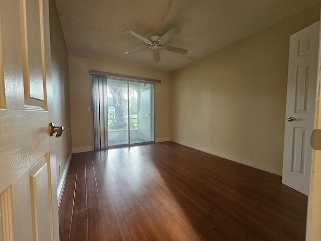 empty room with dark wood-type flooring, ceiling fan, and a textured ceiling