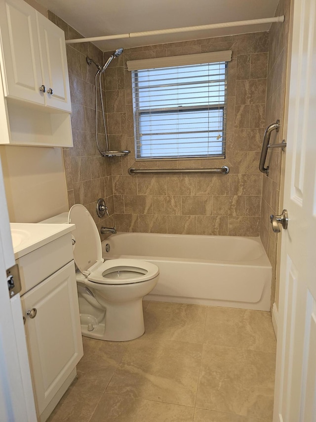 full bathroom with tile patterned flooring, vanity, toilet, and tiled shower / bath