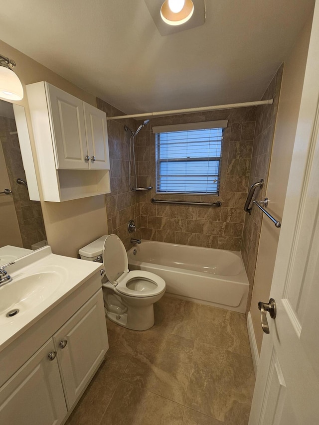 full bathroom featuring tiled shower / bath, toilet, and vanity