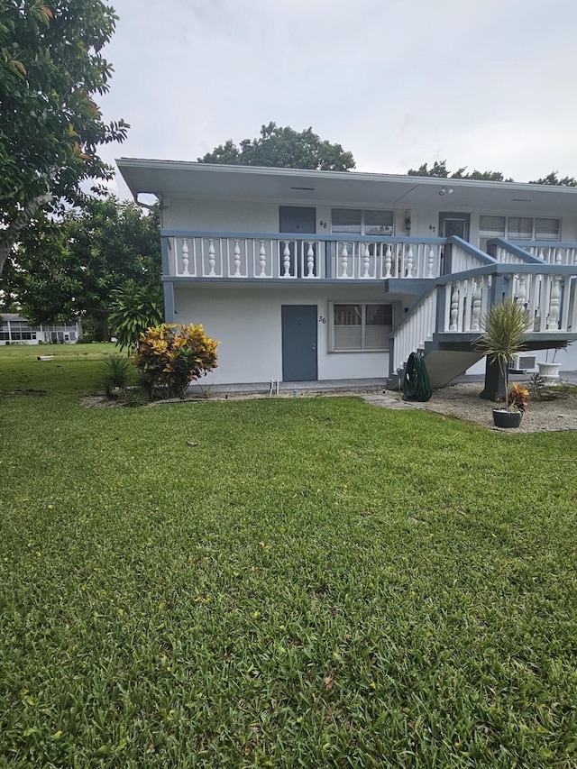 36 Islewood B, Deerfield Beach, FL 33442 - back of property featuring a yard and stairway