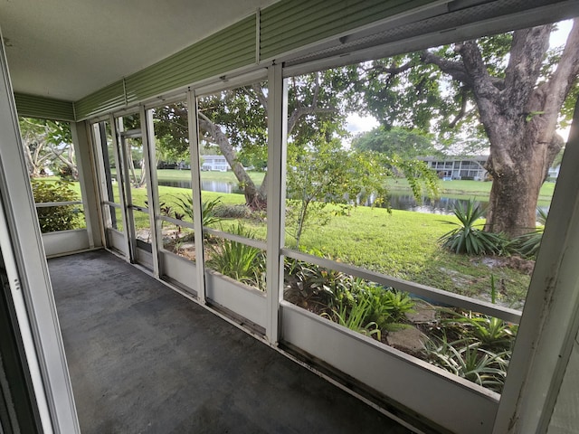 unfurnished sunroom featuring a water view and a healthy amount of sunlight