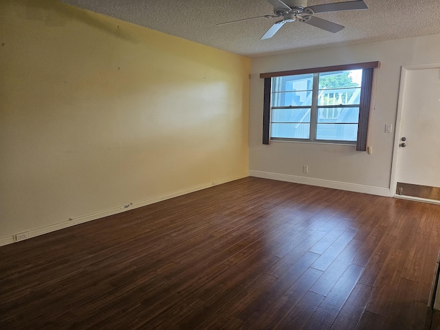 unfurnished room with a textured ceiling, ceiling fan, and dark hardwood / wood-style flooring