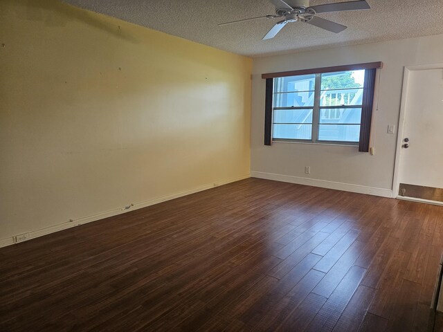 36 Islewood B, Deerfield Beach, FL 33442 - empty room with dark wood finished floors, a ceiling fan, a textured ceiling, and baseboards