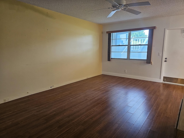 spare room with dark hardwood / wood-style flooring, ceiling fan, and a textured ceiling