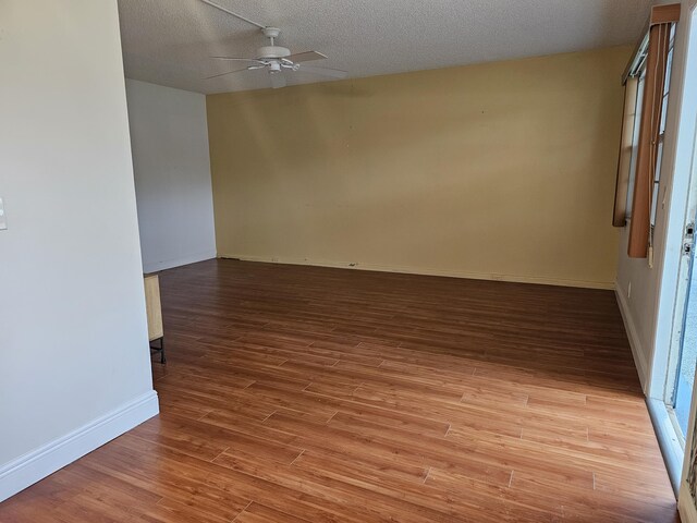 empty room with light wood-type flooring, a textured ceiling, and ceiling fan