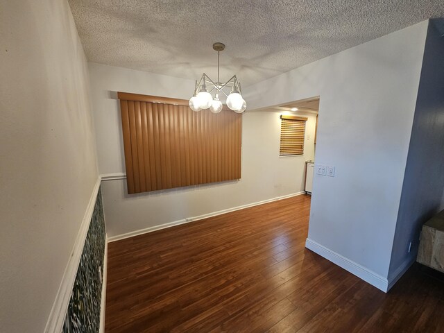 36 Islewood B, Deerfield Beach, FL 33442 - spare room featuring wood finished floors, a chandelier, a textured ceiling, and baseboards