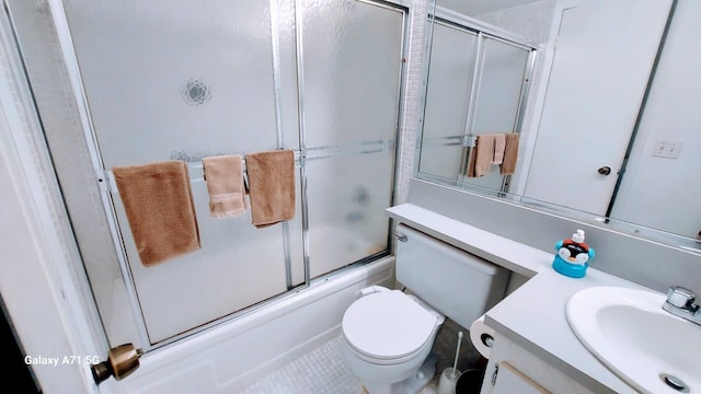 full bathroom with tile patterned floors, vanity, toilet, and combined bath / shower with glass door