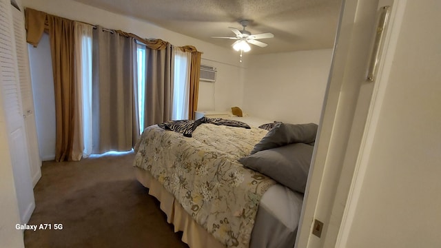 bedroom featuring a textured ceiling, ceiling fan, and carpet