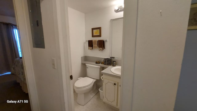 bathroom with vanity, toilet, electric panel, and tile patterned floors