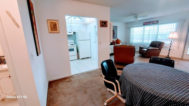 carpeted dining area featuring ceiling fan