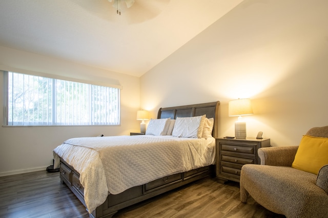 bedroom with dark wood-type flooring, vaulted ceiling, and ceiling fan