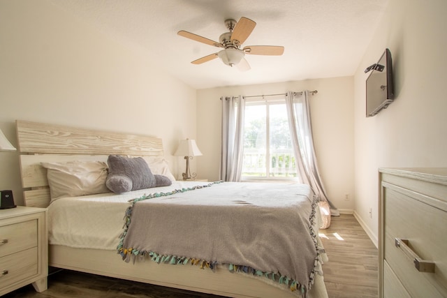 bedroom featuring lofted ceiling, ceiling fan, and hardwood / wood-style flooring