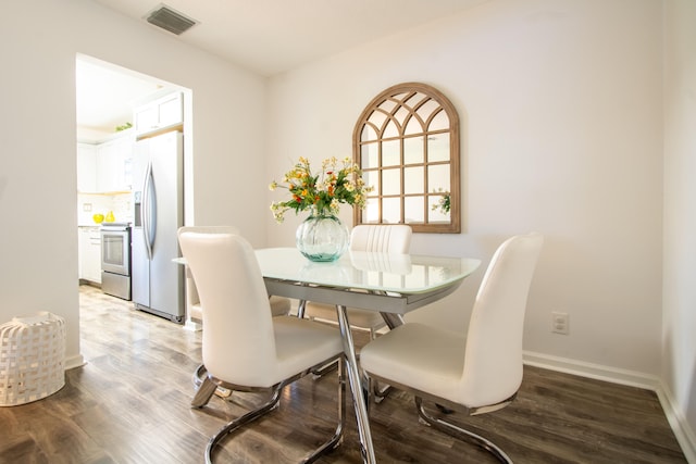 dining area with dark hardwood / wood-style floors